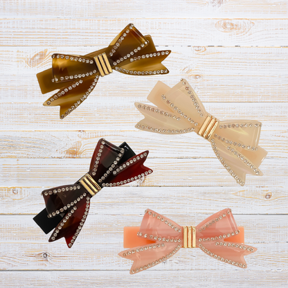 4 barrettes étalées sur table en bois blanc