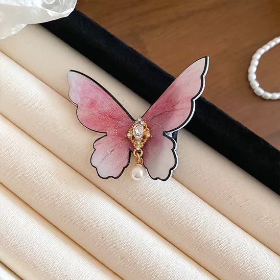 barrette pour les cheveux exposée sur table papillon rose