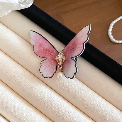 barrette pour les cheveux exposée sur table papillon rose