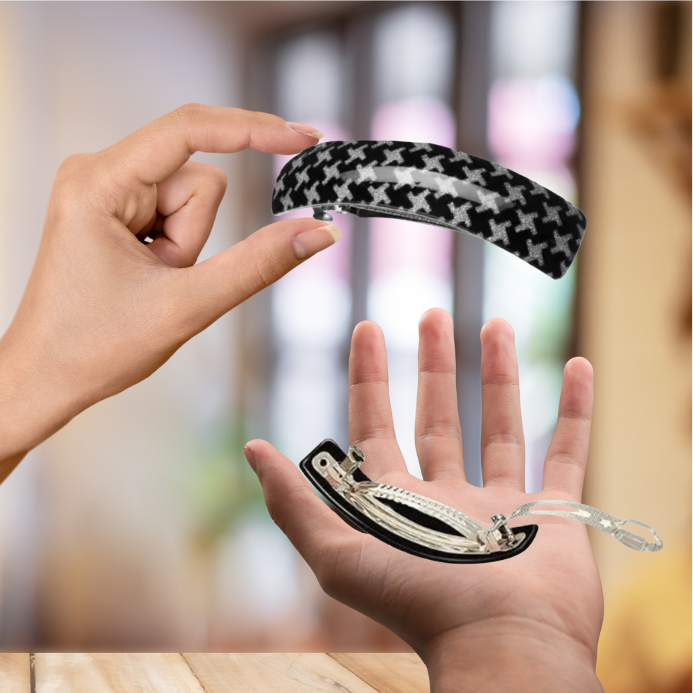 femme dispose dans sa main  barrette noir étoile 